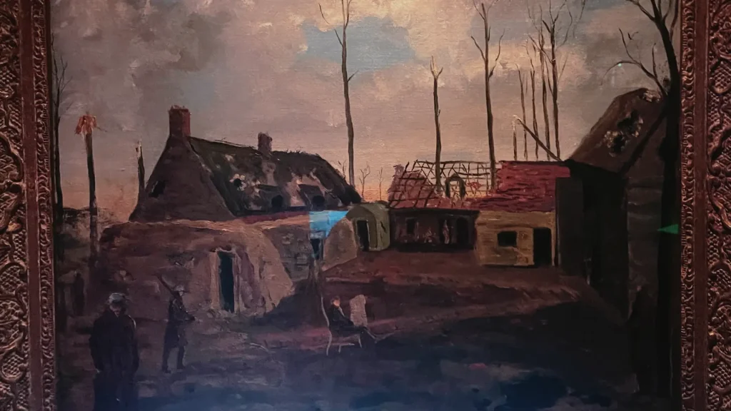A painting depicting a rural scene with bare trees and thatched-roof buildings, possibly a farm. two figures are visible, one standing and one seated. the artwork is framed in an ornate, dark frame.