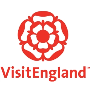 Logo of Visit England featuring a stylized red tudor rose above the brand name in red capital letters.